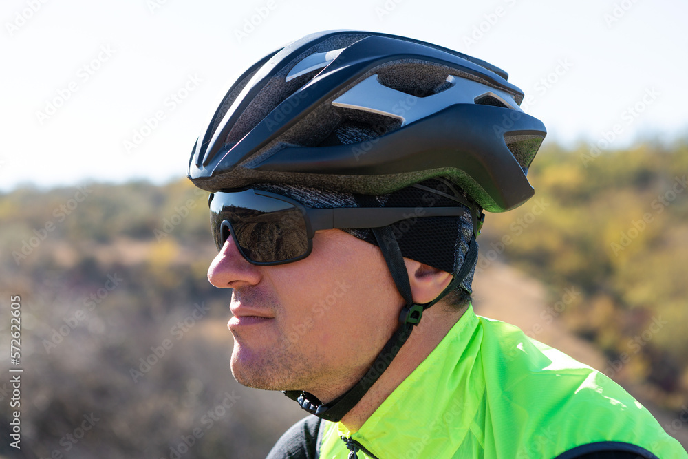 Cyclist riding bicycle on offroad against clear sky. A man in an outfit stands with a bicycle on an autumn sunny day. Cyclist riding bicycle on offroad against clear sky. A man in an outfit stands with a bicycle on an autumn sunny day.