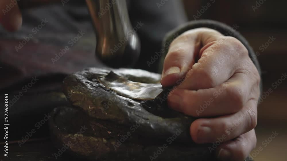 Senior elderly master jeweler in wheelchair works in a workshop Senior elderly master jeweler in wheelchair works in a workshop