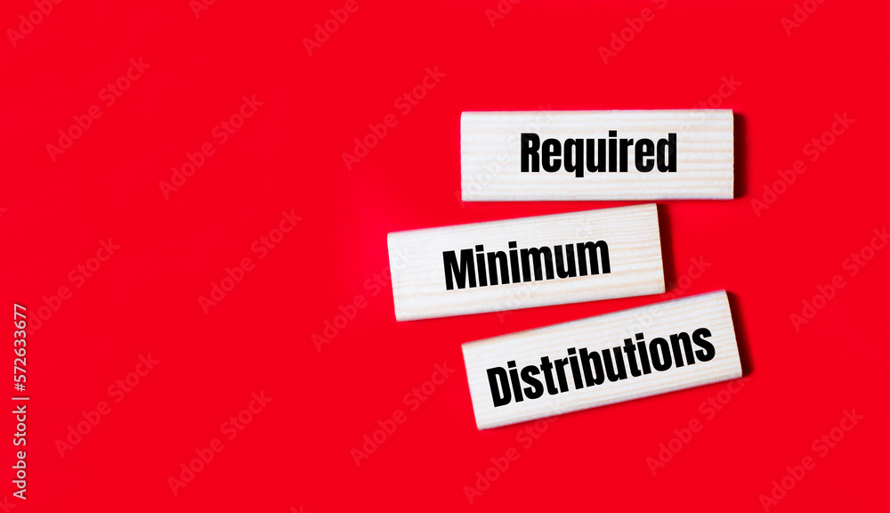 Three wooden blocks with the text RMD Required Minimum Distributions on a bright red background. Copy space Three wooden blocks with the text RMD Required Minimum Distributions on a bright red background. Copy space
