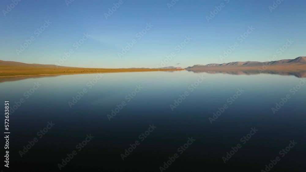 Epic cinematic revealing drone shot moving over Song-Kol lake in Kyrgyzstan Epic cinematic revealing drone shot moving over Song-Kol lake in Kyrgyzstan