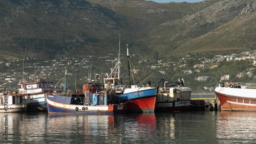 Water level POV passing boats in Hout Bay Harbour Marina, Cape Town, RSA