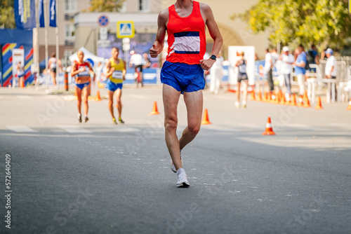 male racewalker at distance in athletics competition photo