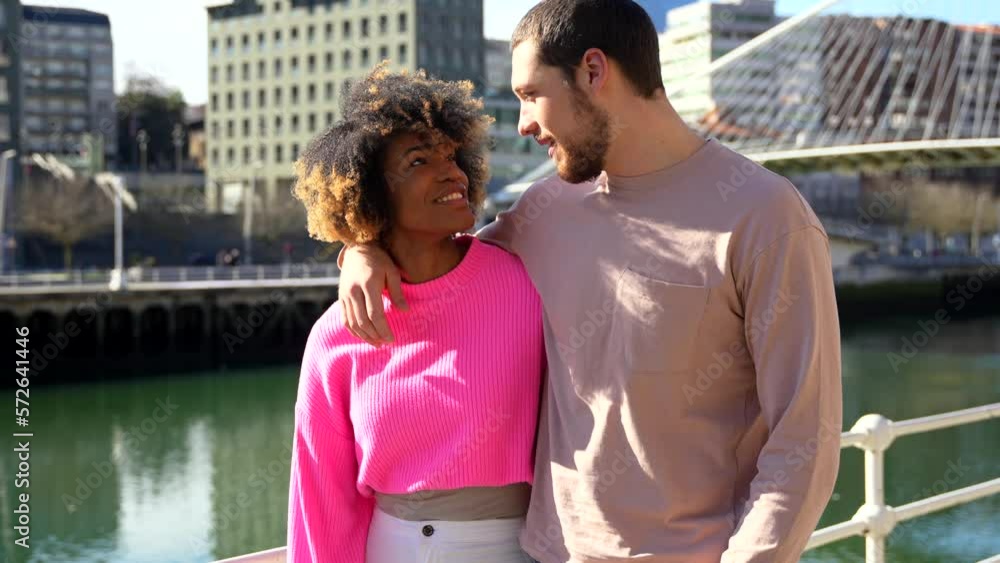 Multiracial friends through the city streets, lifestyle concept, hugging laughing walking Multiracial friends through the city streets, lifestyle concept, hugging laughing walking