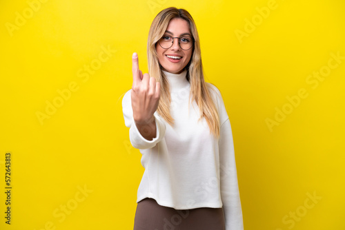 Young Uruguayan woman isolated on yellow background doing coming gesture