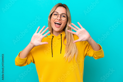 Young Uruguayan woman isolated on blue background counting ten with fingers