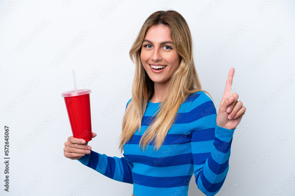 Young Uruguayan woman drinking soda isolated on white background showing and lifting a finger in sign of the best Young Uruguayan woman drinking soda isolated on white background showing and lifting a finger in sign of the best