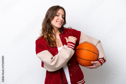 Young caucasian woman playing basketball isolated on white background proud and self-satisfied