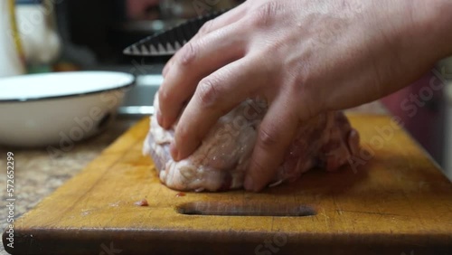 Rural cuisine. Cooking pork in a home country kitchen. Cut tenderloin for steak.