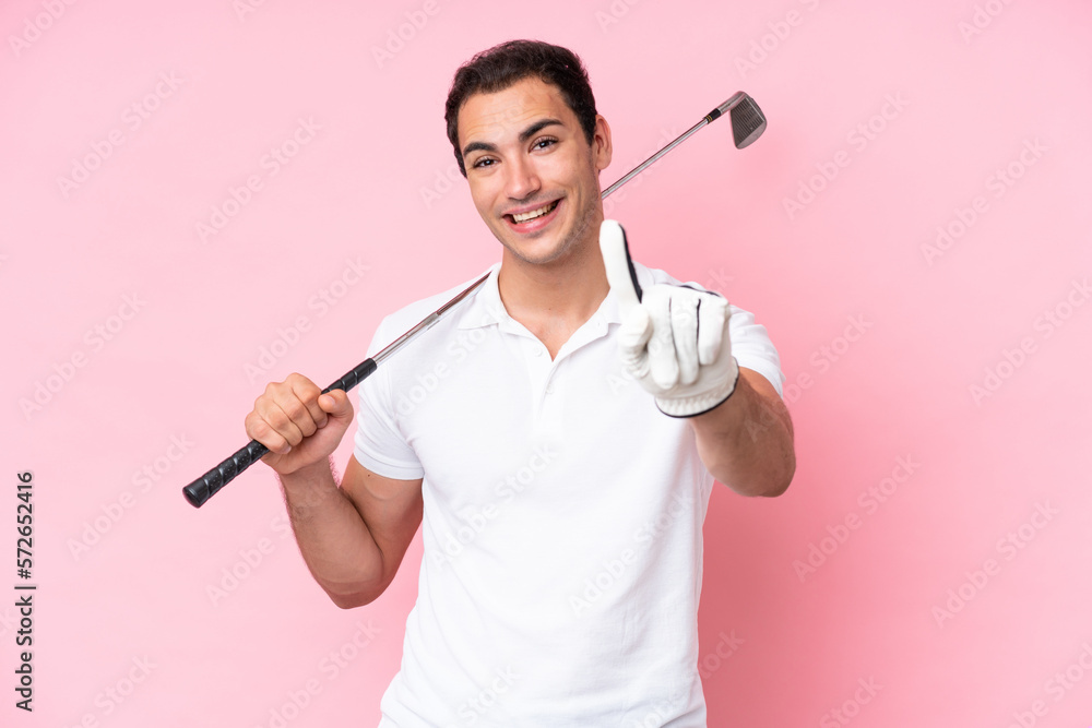 Young golfer player man isolated on pink background showing and lifting a finger Young golfer player man isolated on pink background showing and lifting a finger