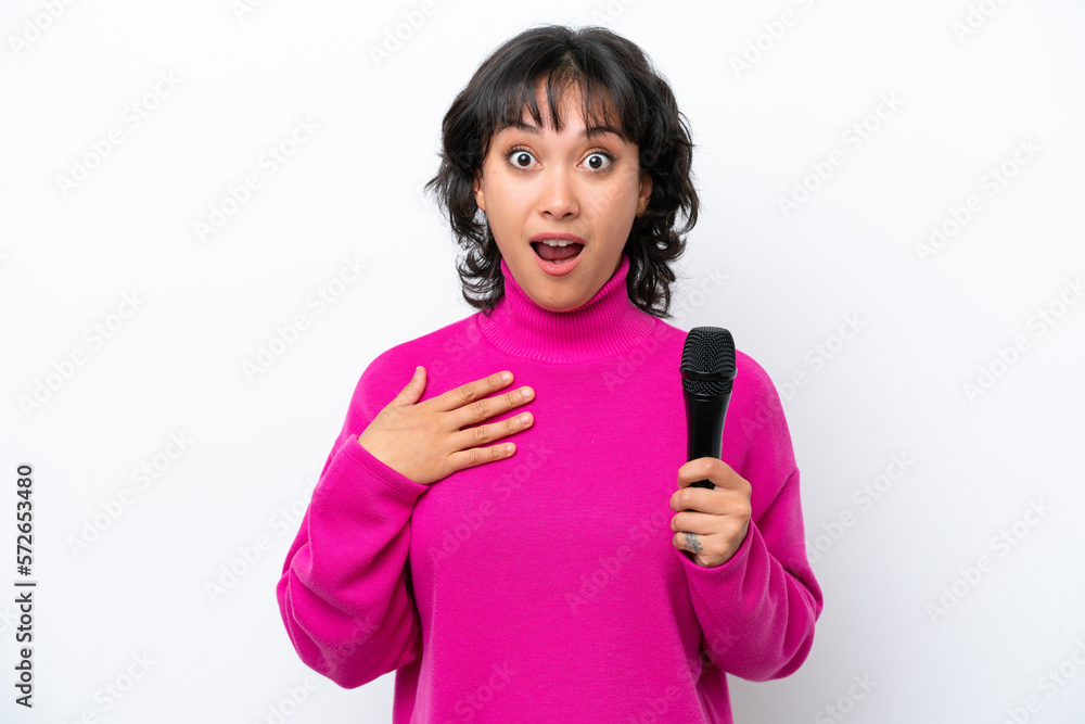 Young Argentinian singer woman isolated on white background surprised and shocked while looking right Young Argentinian singer woman isolated on white background surprised and shocked while looking right