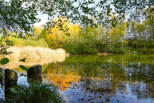 Ostheim natural bathing lake near Malsfeld. Idyllic landscape by the lake in autumn. 
 photo