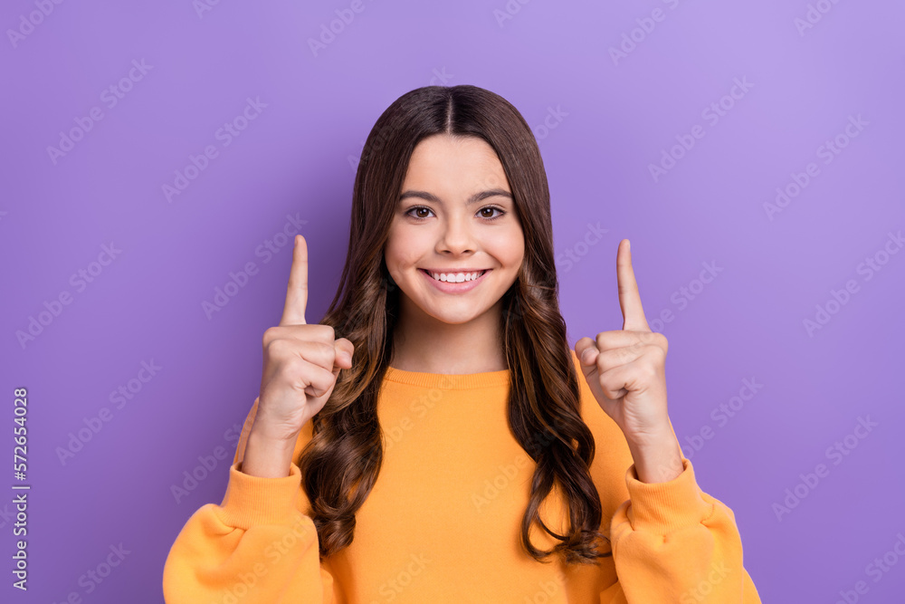 Photo of adorable pretty lady wear stylish orange clothes arm direct empty space novelty feedback isolated on purple color background Photo of adorable pretty lady wear stylish orange clothes arm direct empty space novelty feedback isolated on purple color background