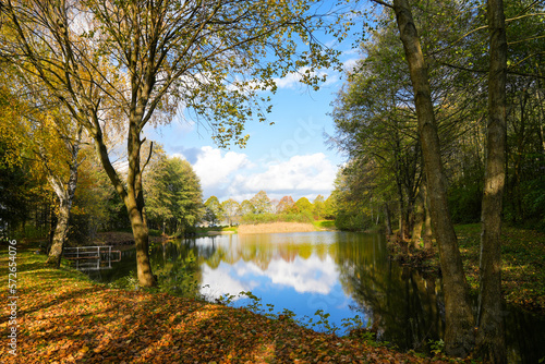 Fototapeta Naklejka Na Ścianę i Meble -  Ostheim natural bathing lake near Malsfeld. Idyllic landscape by the lake in autumn. 
