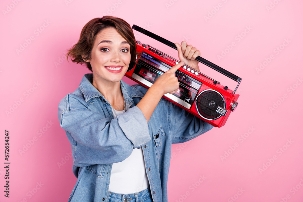Photo of sweet cute lady dressed denim jacket changing radio channel boom box isolated pink color background Photo of sweet cute lady dressed denim jacket changing radio channel boom box isolated pink color background