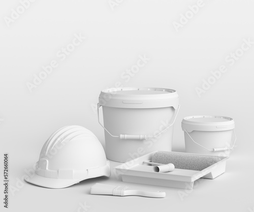 Set of safety helmet, bucket with paint rollers and brushes on monochrome.