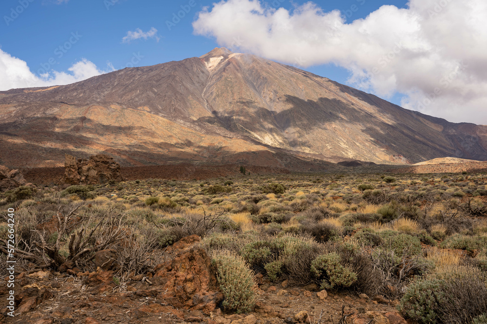 View of the Teide mountain. Pico de Teide with blue sky and clouds in the background. Tenerife, Spain, Europe. View of the Teide mountain. Pico de Teide with blue sky and clouds in the background. Tenerife, Spain, Europe.