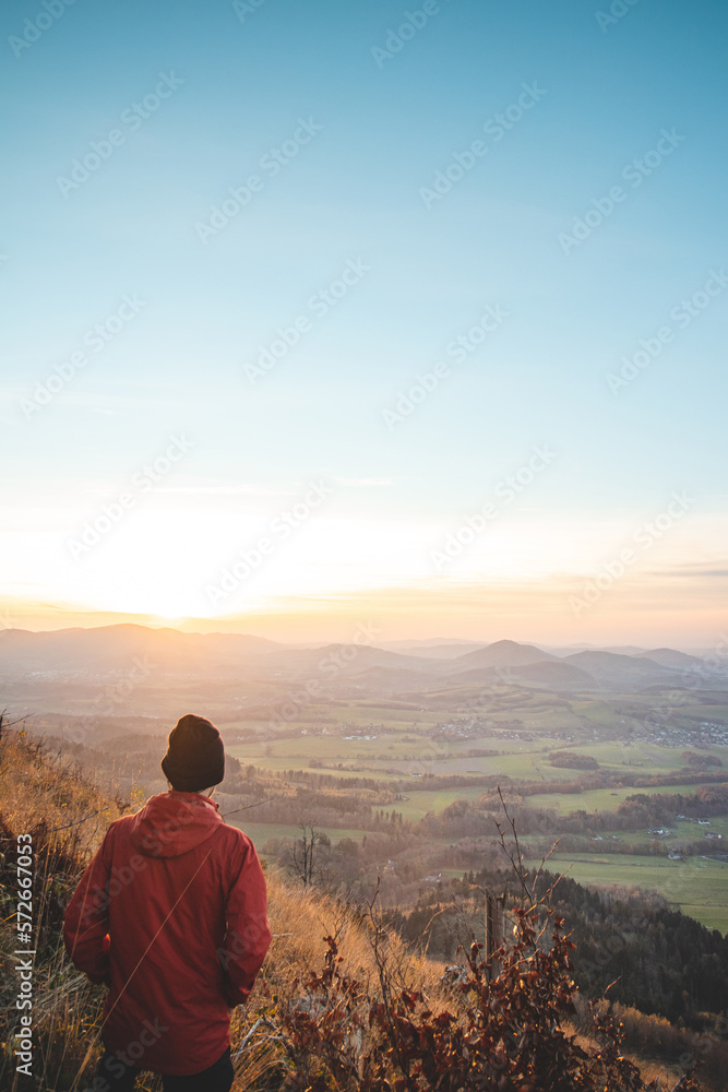 Amazing moment at sunrise as a hiker celebrates his climb up the mountain and completing another point on the map. Trying to complete the journey. Ondrejnik, Beskydy mountains, Czech Republic