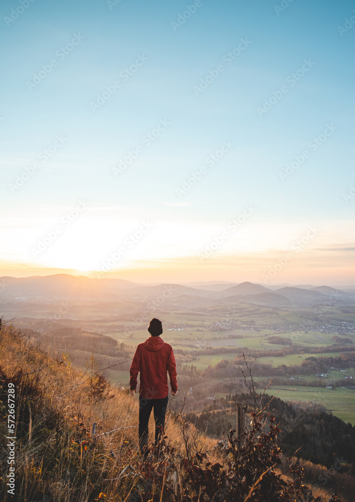Obraz premium Amazing moment at sunrise as a hiker celebrates his climb up the mountain and completing another point on the map. Trying to complete the journey. Ondrejnik, Beskydy mountains, Czech Republic