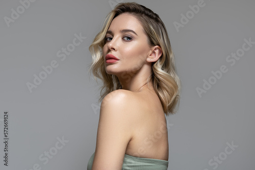 Young beautiful blond woman with hair and makeup. Clean skin. Facial, body and hair care