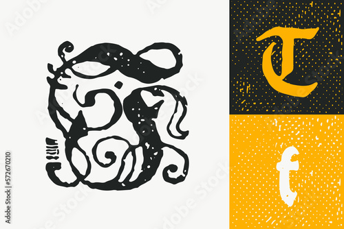 T letter drop cap logo. Illuminated initial and blackletter uppercase and lowercase.