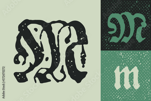 M letter drop cap logo. Illuminated initial and blackletter uppercase and lowercase.