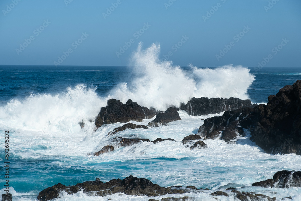ocean waves crashing on rocks, windy weather