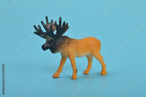 Toy Elk isolated on a blue background © TeacherPhoto