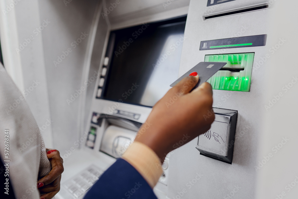 Young african woman withdrawing cash at the ATM Young african woman withdrawing cash at the ATM