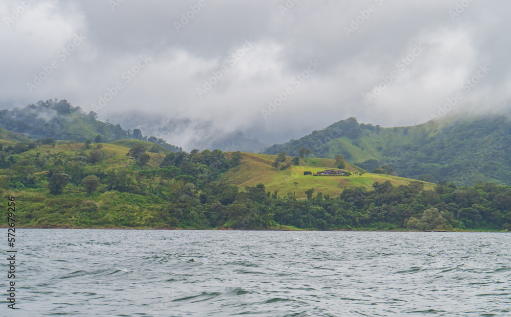 mist and clouds over the lush tropical landscape along Lake Arenal in Costa Rica
