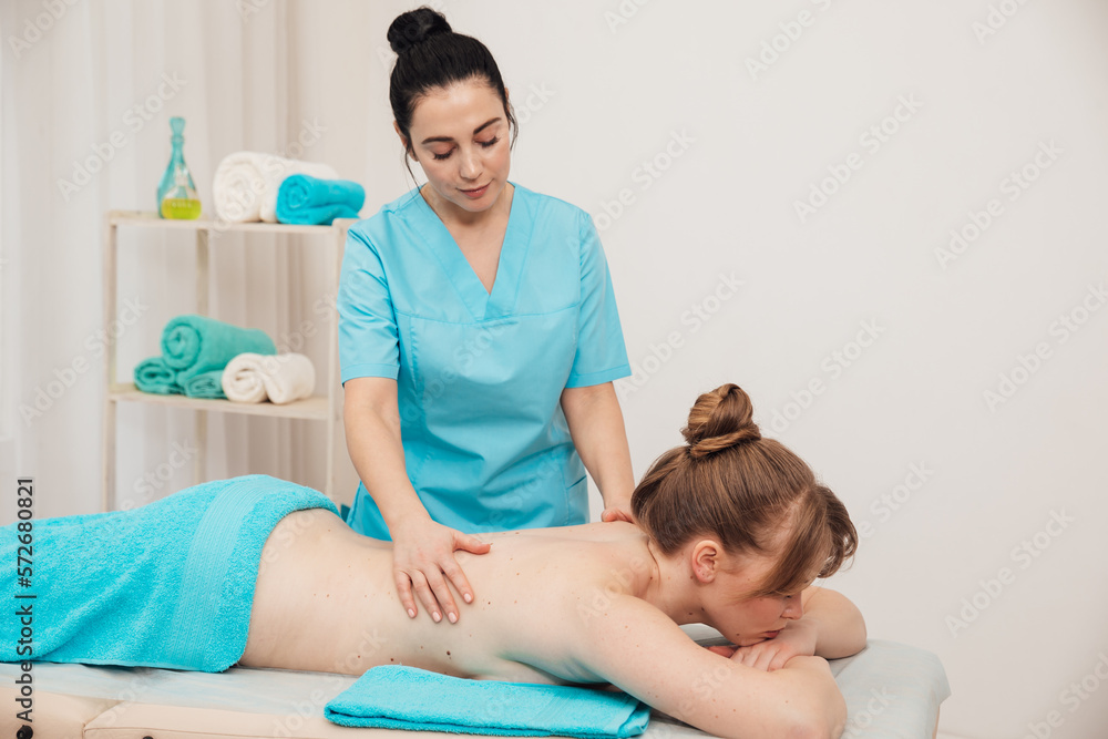 massage therapist does back massage to a woman in the office osteopathy healthy back massage therapist does back massage to a woman in the office osteopathy healthy back