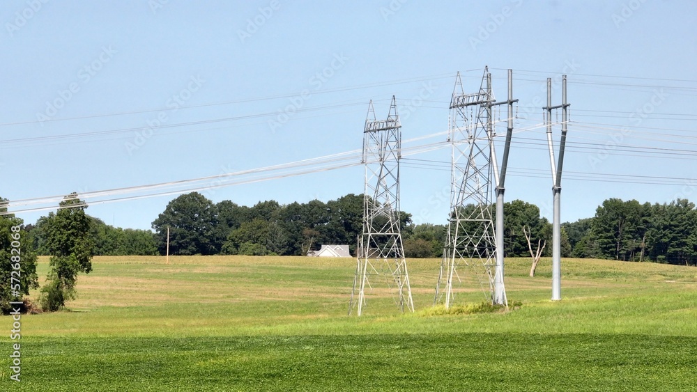 Electric power towers with blue sky and green countryside in America's heartland