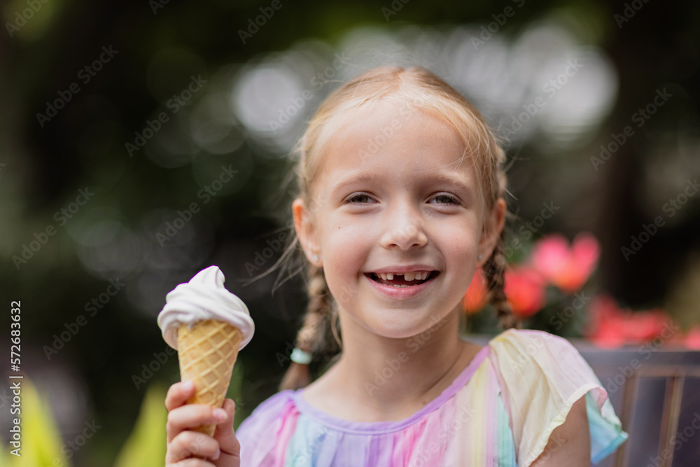 Pretty little caucasian girl with blonde hair eight years old eating licking vanilla ice cream in waffles cone outdoor at hot summer day Pretty little caucasian girl with blonde hair eight years old eating licking vanilla ice cream in waffles cone outdoor at hot summer day