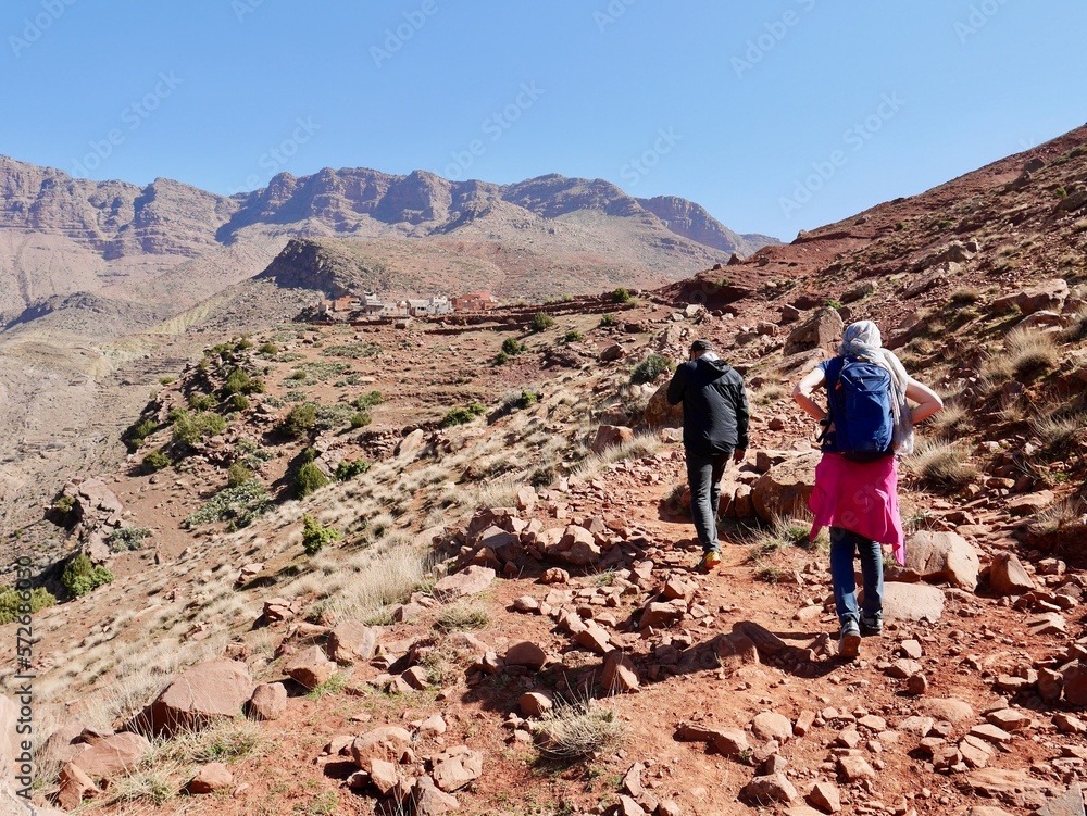  Hikers trekking in Ourika Valley to traditional Berber village Tizi N'Oucheg, High Atlas Mountains, Morocco.