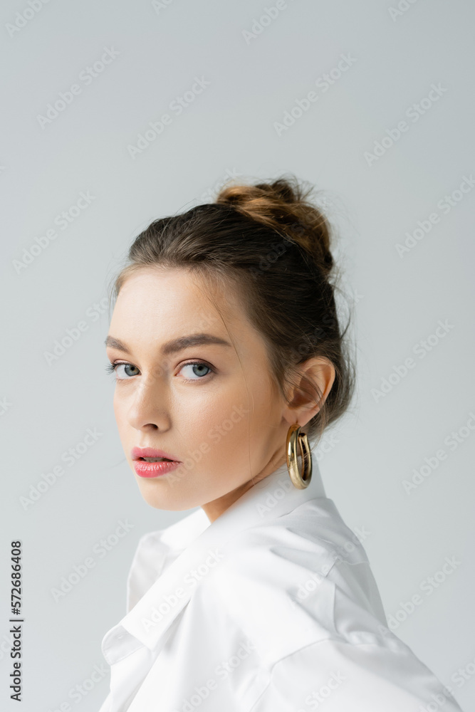 portrait of stylish woman with natural makeup looking at camera isolated on grey. portrait of stylish woman with natural makeup looking at camera isolated on grey.