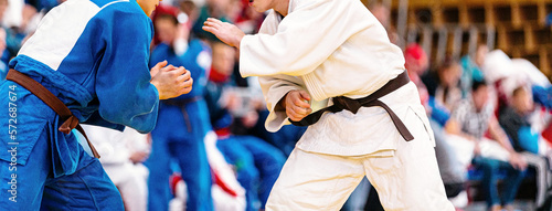 fight of two judoka athletes in judo competition photo