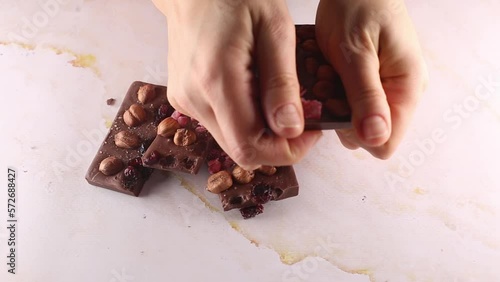 Opened milk chocolate with whole hazel nuts close-up