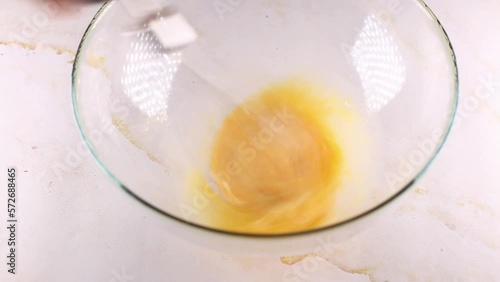 Breaking and mixing breaks chicken eggs into a bowl.
