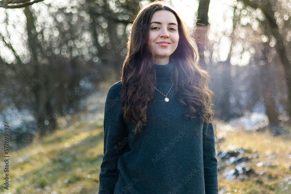 Portrait of a woman in nature.Emotions of happiness.Girl in the forest.Woman with long curly hair.Photo in motion.The wind blows on her hair.Beautiful sunlight in the forest.Hair care.Walking.vintage. Portrait of a woman in nature.Emotions of happiness.Girl in the forest.Woman with long curly hair.Photo in motion.The wind blows on her hair.Beautiful sunlight in the forest.Hair care.Walking.vintage.