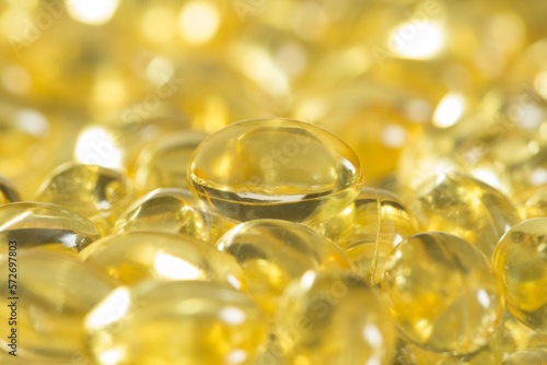 Fish oil capsules spilled to make a background. Close up shot
