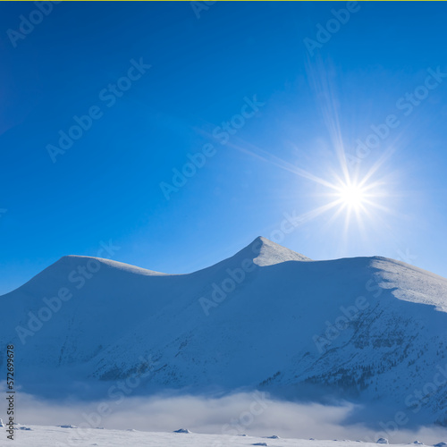 snowbound mountain chain at sunny day  winter travel background