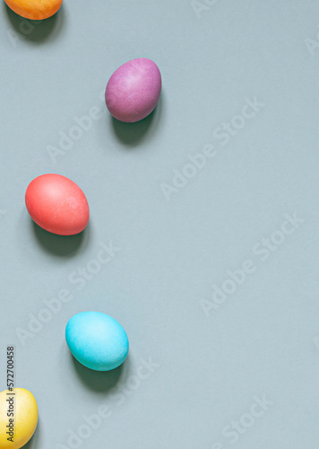 Colorful painted Easter eggs on the grey background. Top view. Copy space