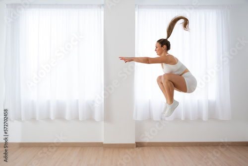 Fototapeta Naklejka Na Ścianę i Meble -  Young woman working out jumping