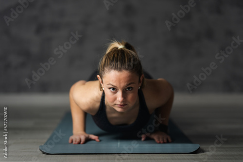 Front view of serious woman doing push ups