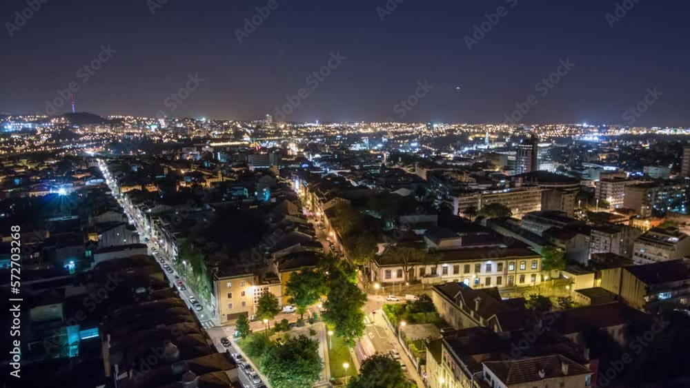 Aerial panoramic view over Rooftops of Porto's old town with TV tower night timelapse with illuminated historic buildings, Porto, Portugal. Traffic on city streets Aerial panoramic view over Rooftops of Porto's old town with TV tower night timelapse with illuminated historic buildings, Porto, Portugal. Traffic on city streets