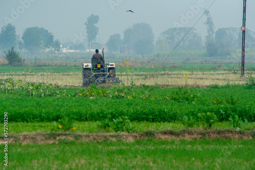 Fotografie Tractor ploughing Field in Punjab, India