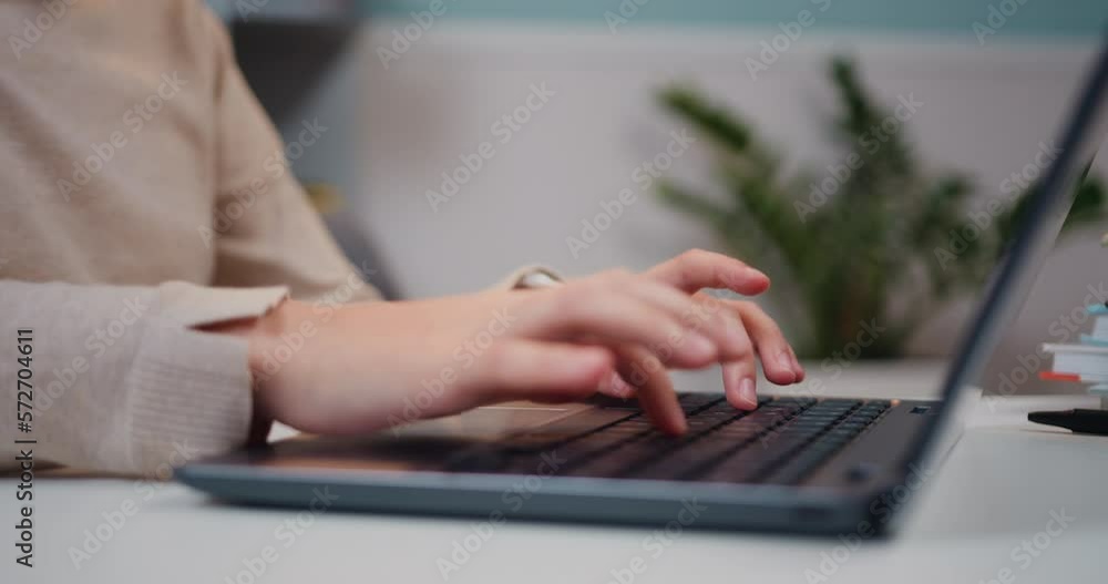 Close up hands of little girl typing on keyboard laptop. Schoolgirl typing on laptop keyboard, e-learning online communication. Kid use computer for education does homework, online education Close up hands of little girl typing on keyboard laptop. Schoolgirl typing on laptop keyboard, e-learning online communication. Kid use computer for education does homework, online education