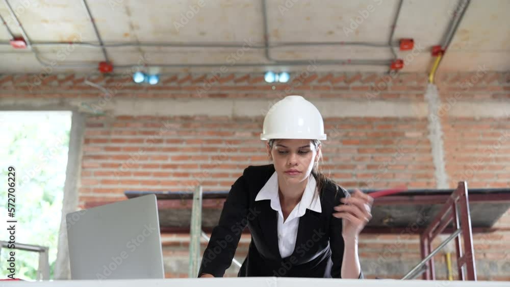 Caucasian female architect working on construction site. Caucasian female architect working on construction site.