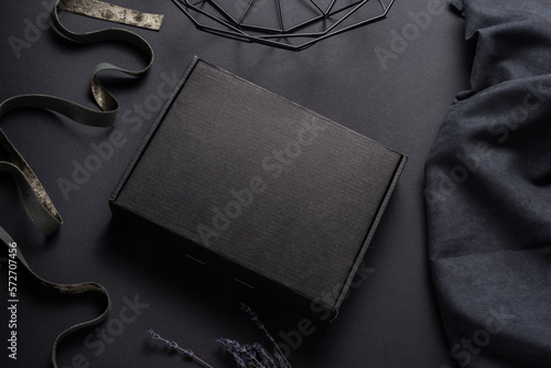 Black cardboard package box on dark background