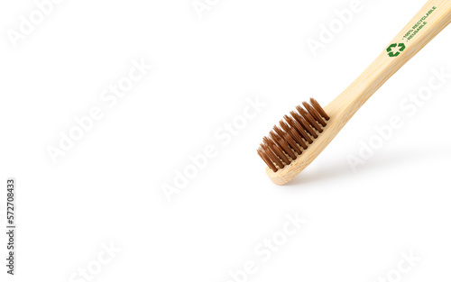 Zero waste concept. Bamboo toothbrush with a recycling sign on a white background