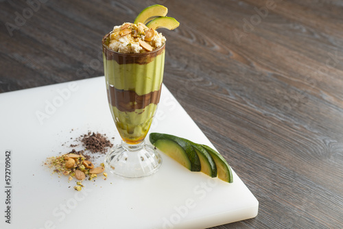 Fresh avocado cocktail and chocolate with pistachio, ashta and honey topping 
 photo